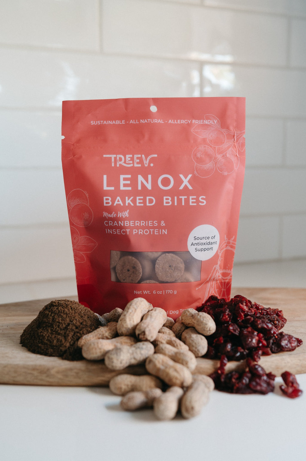 TREEV Lenox Baked Bites bag with dried cranberries, peanuts and powdered protein on a wooden board