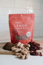 TREEV Lenox Baked Bites bag with dried cranberries, peanuts and powdered protein on a wooden board