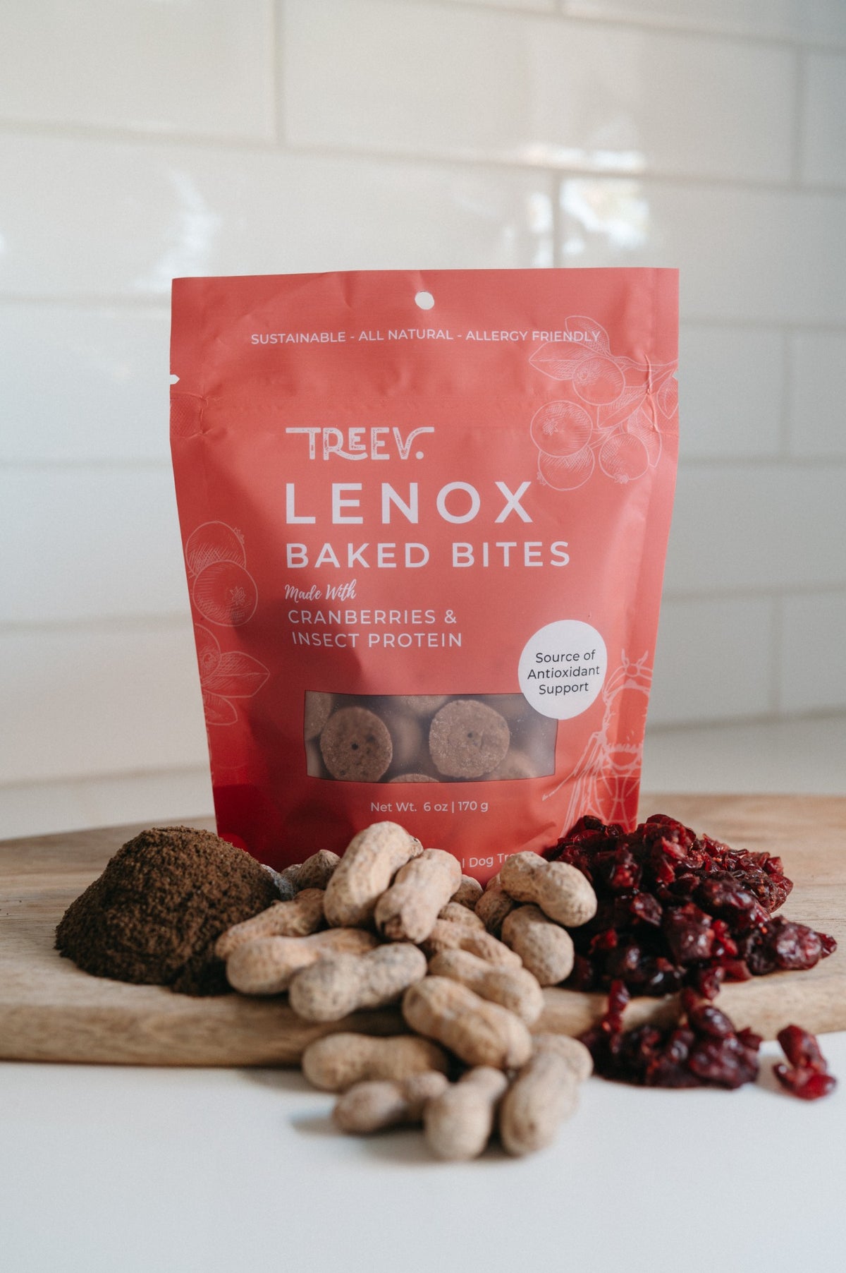 TREEV Lenox Baked Bites bag with dried cranberries, peanuts and powdered protein on a wooden board