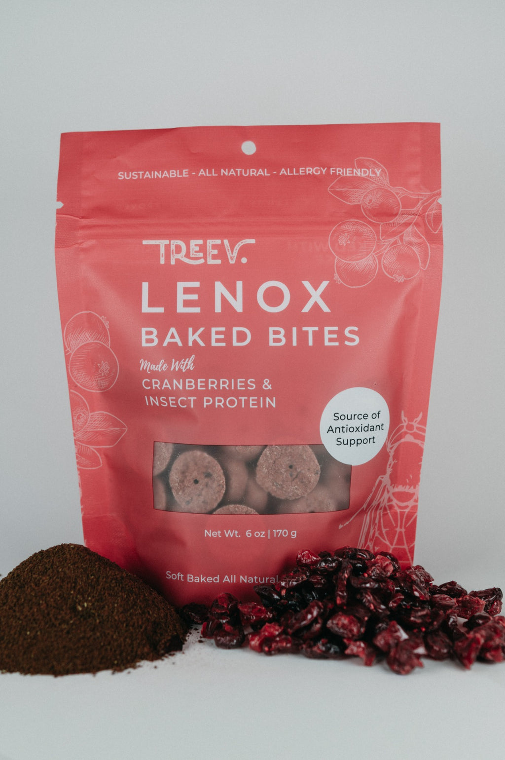 TREEV Lenox Baked Bites bag beside dried cranberries and a pile of powdered protein